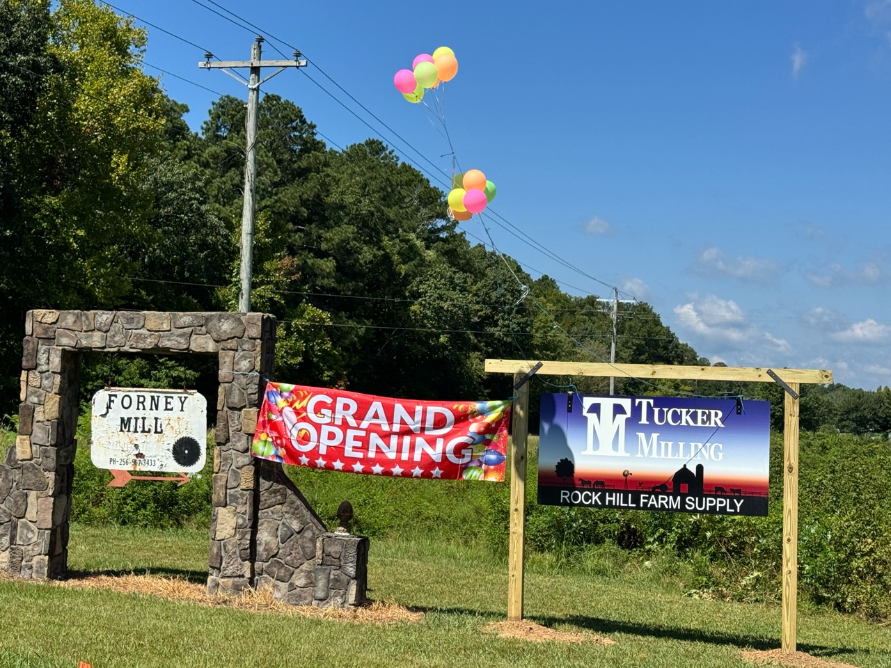 Grand opening and Tucker Milling signs at Rock Hill Farm Supply