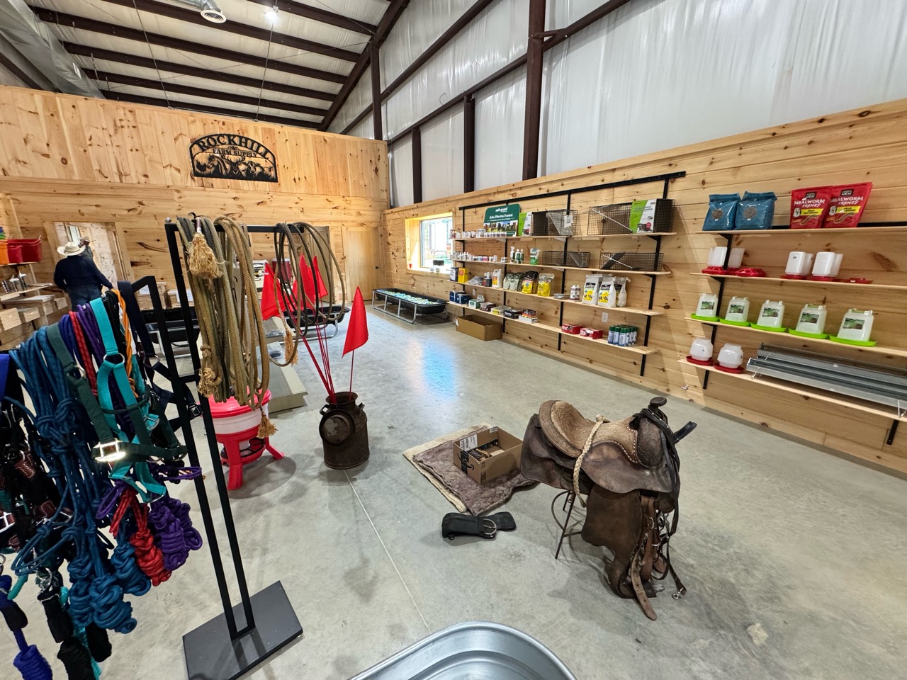 Tack, animal-care products, and a saddle inside Rock Hill Farm Supply