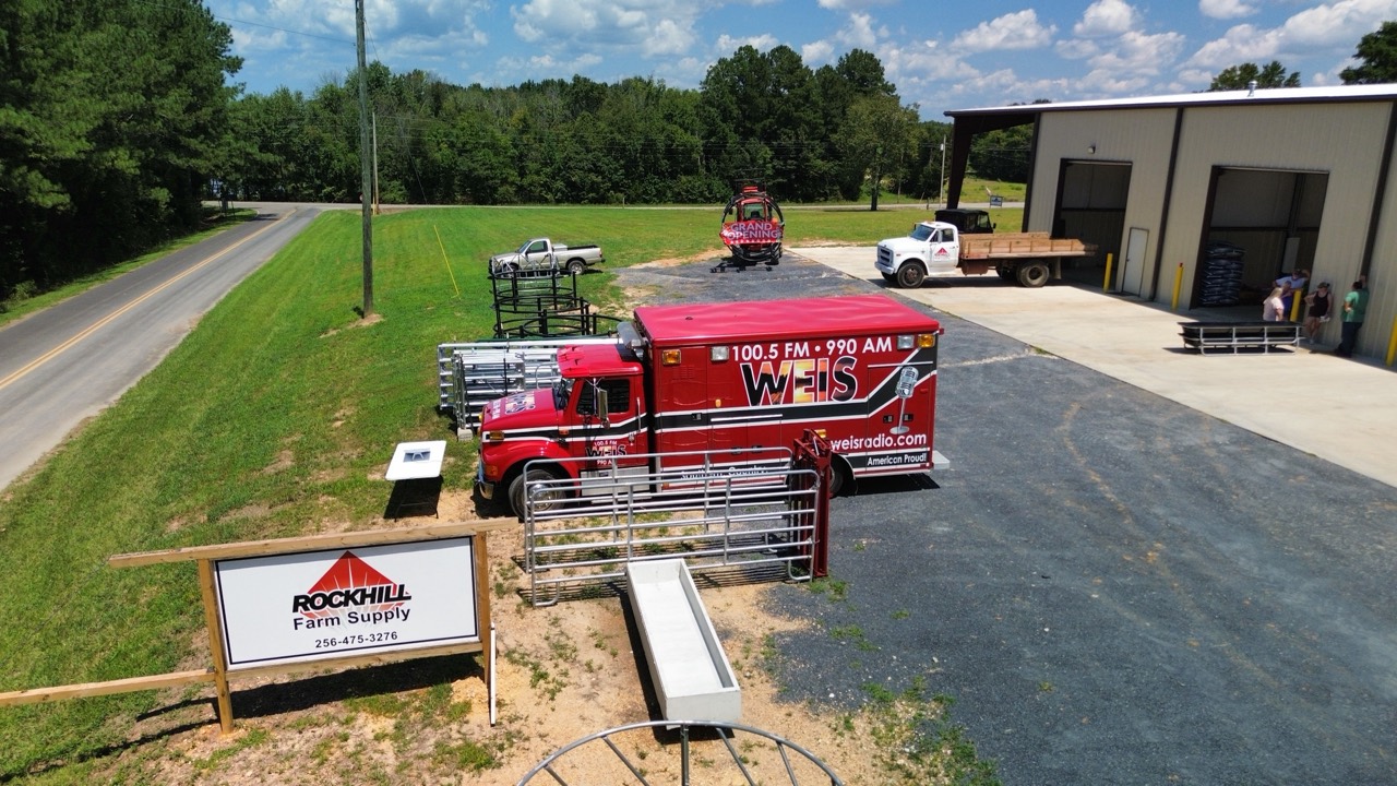 Rock Hill Farm Supply sign and WEIS radio truck at the grand opening