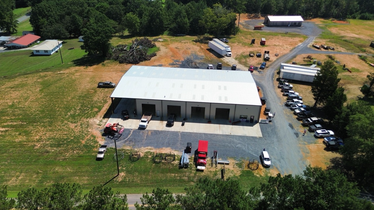 Overhead view of the store, parking area, and farm equipment